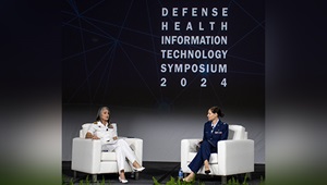 U.S. Public Health Service Rear Adm. Tracy Farrill, in her role as MHS GENESIS functional champion for the Defense Health Agency, has a fireside chat with U.S. Air Force Col. Tara Conner, chief health informatics officer at the DHA Health Informatics Division, during a plenary session at the 2024 Defense Health Information Technology Symposium in Dallas, Texas, on Aug. 20, 2024. The Defense Health Agency is working to improve the end-user experience of MHS GENESIS, the Department of Defense federal electronic health record. 