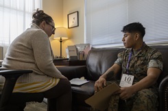 U.S. Marine Corps Pfc. Christian Luna Salvador, right, a postal clerk with Headquarters and Support Battalion, Marine Corps Installations Pacific, speaks to Tarra Brannon, a social worker with Marine Corps Community Services Okinawa, in a family evacuation drill during Exercise Constant Vigilance 2022 on Camp Foster, Okinawa, Japan, on Oct. 20, 2022. The Military Health System offers many services to service members in a variety of settings in times of stress and anxiety. (credit: U.S. Marine Corps Lance Cpl. Thomas Sheng)