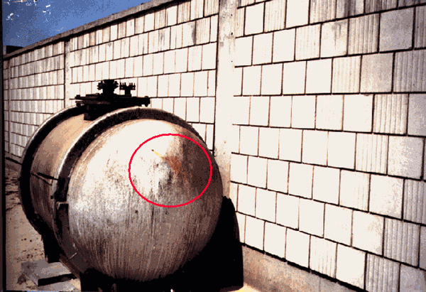 Figure 8. Photographs of the storage tank at the Kuwaiti Girls' School taken by the safety officer in August 1991. Encircled areas show the movement of the fumes out of one of the bullet holes. (Photographs used by permission.)