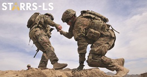 Service member helps another up a mountain