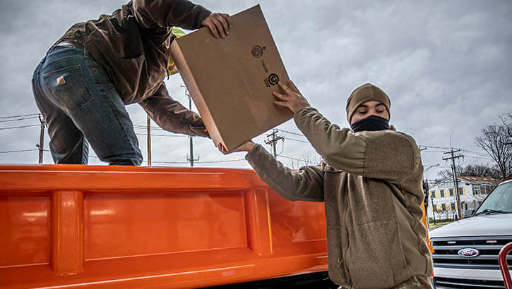 Image of A Soldier assigned to the Connecticut National Guard helps load a shipment of at-home COVID-19 testing kits into a truck at a regional distribution point in North Haven, Connecticut, Jan. 3, 2022. These kits were picked up by representatives from local towns and municipalities to be handed out to their communities.