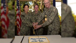 A slice of 113 years… Capt. Molly Jenkins, Navy Medicine Readiness Training Command Bremerton executive officer and Dental Corps officer is flanked by Capt. Patrick Fox, staff dental officer (right) and Lt. Bueniel Kim, general dentist, in the traditional cake cutting ceremony held in recognition of their birth