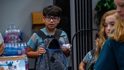 Boy with backpack shopping 