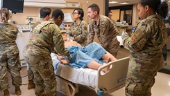 Airmen with the 2nd Medical Group simulate treatment for a gunshot wound.