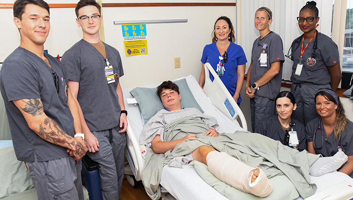 Image of Boy who suffered shark attack is surrounded by his team of health care professionals at Naval Medical Center Camp Lejeune.