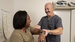 Doug Dusenberry, orthopaedic physician assistant, examines a patient at Brooke Army Medical Center, Fort Sam Houston, Texas, on Aug. 3, 2023. Dusenberry is one of BAMC’s providers who were named as Best of the Best in a recent Joint Outpatient Experience Survey quarterly report. (DOD photo by Jason W. Edwards)