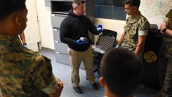 U.S. Air Force Staff Sgt. Brandon Trapani, Security Forces Non-commissioned Officer in Charge, Joint Military Working Dog (MWD) Program, trains U.S. Marine MWD Handlers on narcotic training aid prototype capabilities at Marine Corps Base Quantico, Virginia, September 17, 2024. The prototype was developed due to a recent uptick in narcotic training aids returned damaged or inoperable due to various mission-related circumstances. (U.S. Air Force photo by Staff Sgt. Deven Schultz)