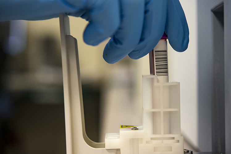 Image of Staff Sgt. Cory Gage, 23d Medical Support Squadron medical laboratory technician, places a blood specimen in an automated hematology analyzer, Aug. 29, 2017, at Moody Air Force Base, Ga. Moody’s lab technicians process blood to check for a variety of cell abnormalities from infections to cancer. (U.S. Air Force photo by Airman 1st Class Erick Requadt).