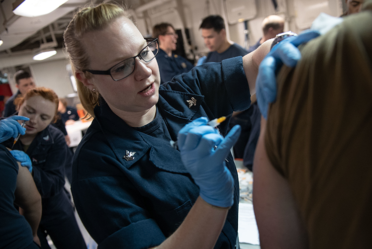 Image of Adminstration of a seasonal flu vaccination. (U.S. Navy photo).