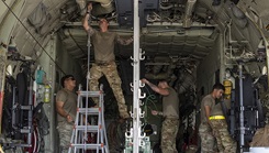U.S. Air Force Airmen assigned to the 374th Airlift Wing and 18th Air Evacuation Squadron rig a C-130J Super Hercules for a mass casualty exercise