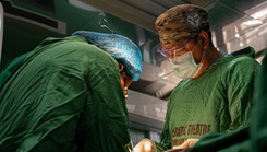 U.S Army Capt. Patrick Benoit, a general surgeon assigned to the Landstuhl Regional Medical Center, operates on a child during the medical readiness exercise
