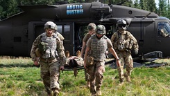Airmen assigned to the 168th Medical Group, Alaska Air National Guard, train on loading and offloading patients from a UH-60 Black Hawk helicopter during an advanced TCCC training