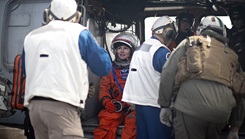 U.S. Navy and NASA medical personnel simulate a medical examination of an Astronaut aboard amphibious transport dock USS Somerset (LPD 25) during NASA Underway Recovery Test 12 medical drills in the Pacific Ocean