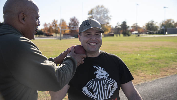 Image of Two people with a shotput.