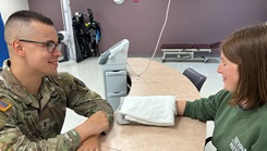 U.S. Army 1st Lt. Jonathan Ekas, an occupational therapist at Bayne-Jones Army Community Hospital, uses heat to treat de quervain tenosynovitis, a painful condition affecting the tendons on the thumb side of Shelby Snyder's wrist during an appointment. Snyder, a local artist and the spouse of U.S. Army Capt. Richard Snyder, Task Force Live Fire, Operations Group, is near the end of her journey to recovery that wrapped up with the enhanced hand and wrist surgical capabilities offered during the “hand rodeo,” Aug. 24-25, at the Joint Readiness Training Center in Fort Johnson, Louisiana. (Photo By Jean Graves, BJACH public affairs)