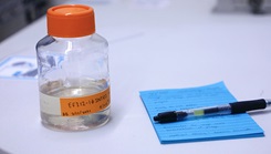 Medicine sitting beside a pen and pad