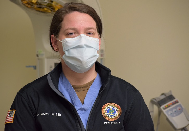 Image of Military health personnel wearing a face mask posing for a picture.