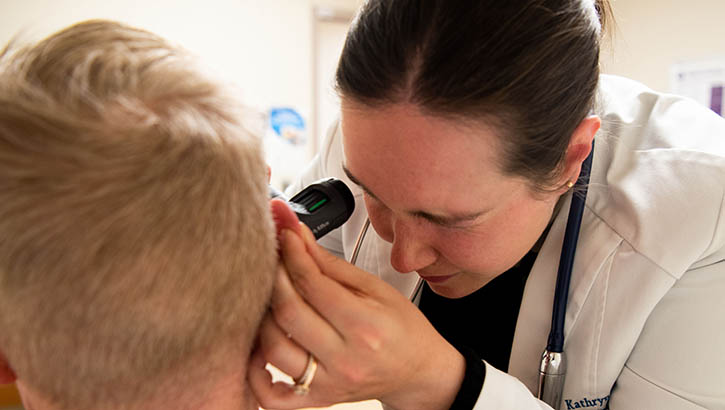 U.S. Navy Lt. Kathryn Flynn examines a patient