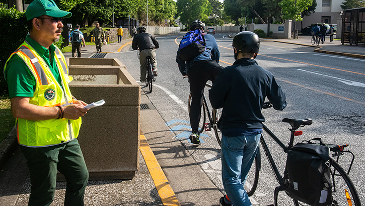 Image of A safety officer overlooks bike riders on a street.