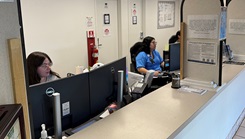 Rebecca Untalan, left, and Heather Chaparro, patient administration professionals at Branch Health Clinic Makalapa, provide support to incoming patients at the newly-integrated front desk