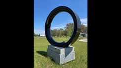 a statue of a broken circle