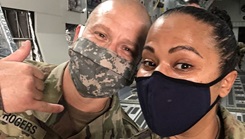 Military personnel wearing face mask posing for a picture