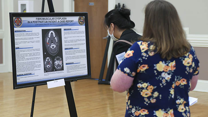 Image of Military personnel looking at display.