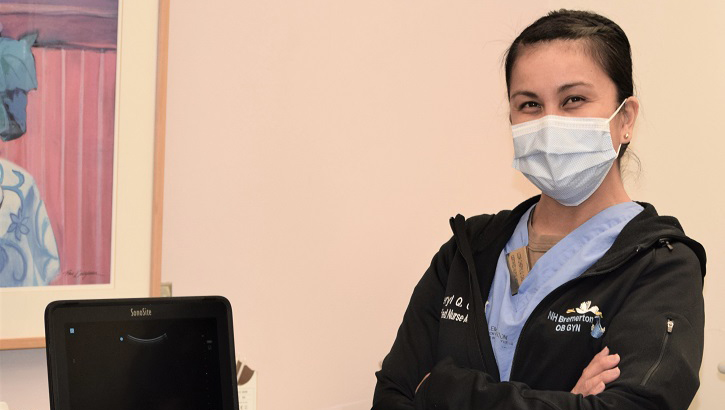 Image of Military health personnel wearing a face mask posing for a picture.