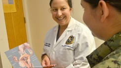 Image of medical personnel showing report to soldier. Click to open a larger version of the image.