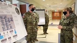 A male soldier talks about a chart to to a female sailor.