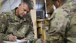U.S. Army Lt. Col. Harry Jenkins, left, Combined Joint Task Force—Horn of Africa physical therapist, conducts a physical therapy consultation for U.S. Army Sgt. 1st Class Thomas Arriola, CJTF - HOA force protection liaison officer, at Cooperative Security Location, Kismayo, Somalia