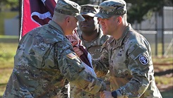 Col. Patrick Miller, commander of Bayne-Jones Army Community Hospital, passes the unit guidon to Command Sgt. Maj. Victor M. Contreras Jr. during the change of responsibility ceremony