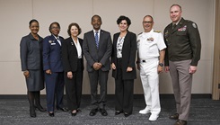 Leaders from the Uniformed Services University, the Office of the Secretary of Defense, and the Army, Navy, and Air Force Nurse Corps pose for a photo