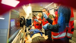 Medical students work on stabilizing a patient