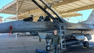 Resident performs preflight inspection of her aircraft in preparation for 9G training.