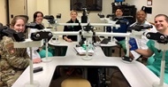 Cytopathology faculty sitting around the multi-headed microscope during the Cytology Interesting Case Conference, led by the fellowship program director and cytopathology fellow. Cytopathology faculty and trainees attend this conference weekly.