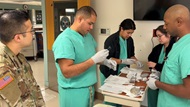 Cytopathology trainee utilizing “see one, do one, teach one” approach to learning Fine Needle Aspiration cytology smear technique.  