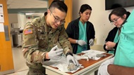 Cytopathology trainee practicing Fine Needle Aspiration of a mock palpable lesion in the Simulation Laboratory. 