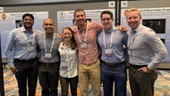 Emergency medicine resident physicians presenting research at national conference.