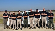 SAUSHEC and UTHSA EMS fellows stand in front of the physician response vehicle after completing a tactical driving course.