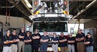 SAUSHEC and UTHSA EMS fellows and faculty in front of an SAFD platform. 