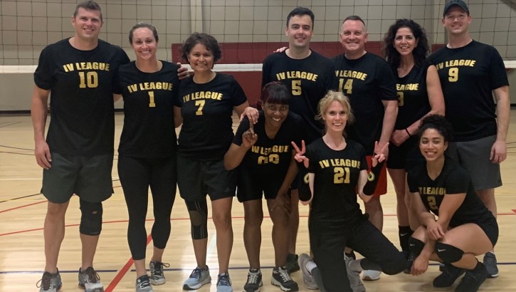 A group of Hematology Medical Oncology fellows and faculty are playing a game of volleyball. 