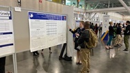 A physician presents her clinical research at a national meeting. 