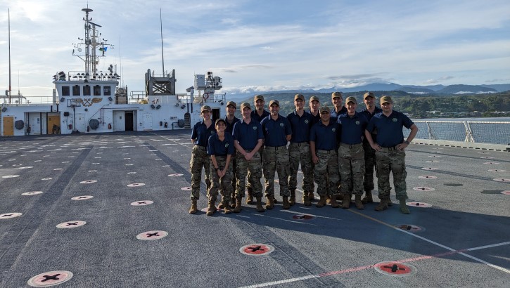 A group of residents pose on the flight deck of the USNS Mercy after assisting TDY on a medical mission.