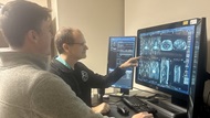 A radiologist performs a readout with a resident on service. 