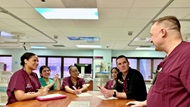 A neonatologist conducts multi-disciplinary rounds in the NICU with team members including the resident, nurse, and respiratory therapist. 