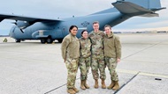 Members of a neonatal transport team stand in front of a C-17 aircraft after completion of a neonatal transport mission. 