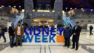 Four fellows standing in front of a Kidney Week 2023 sign. 