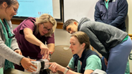 Ob-Gyn Residents practicing using simulated equipment.  