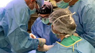 Staff physicians teaching residents and medical students in the operating room.